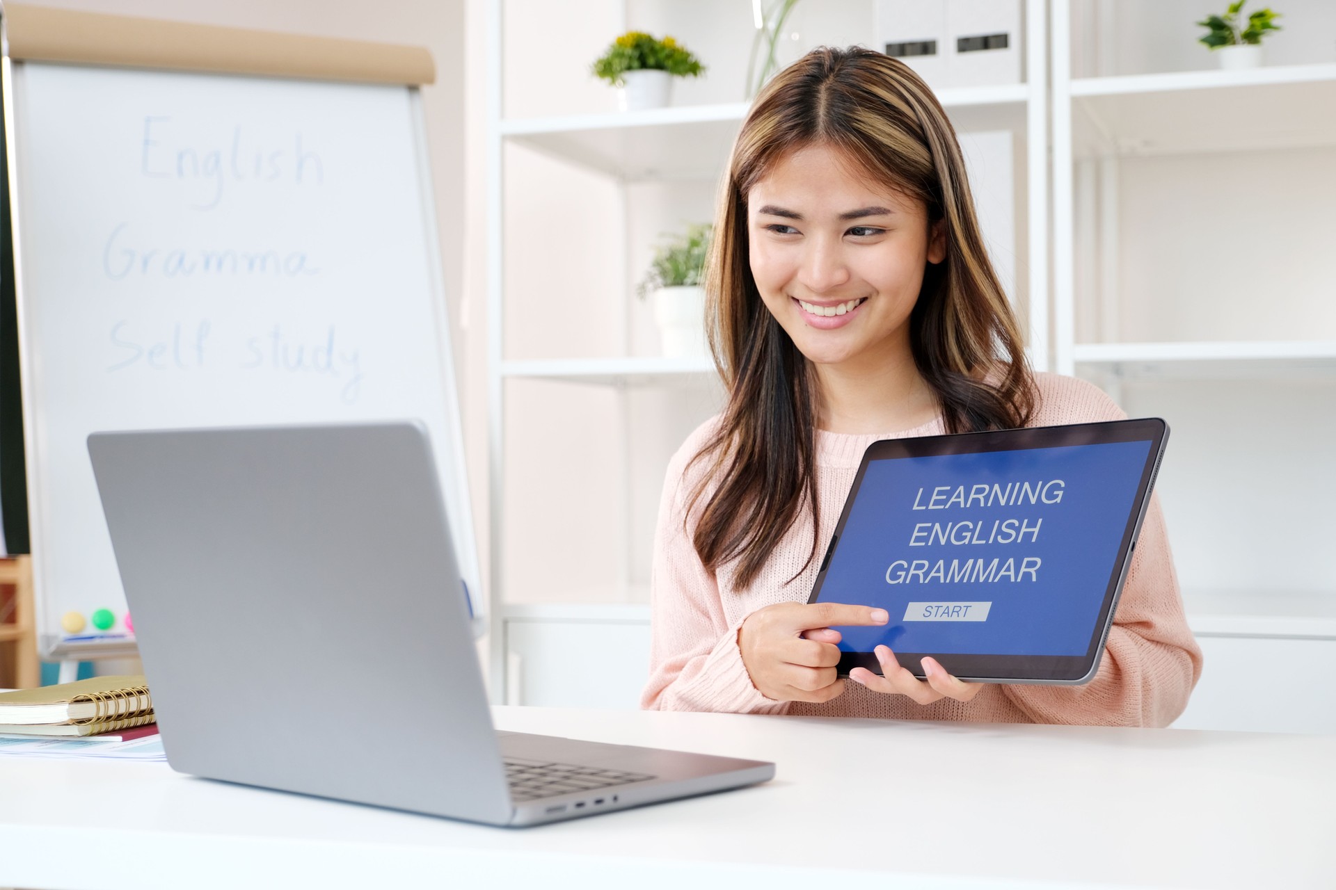 Young asian woman, english teacher holding digital tablet while teaching english language online class